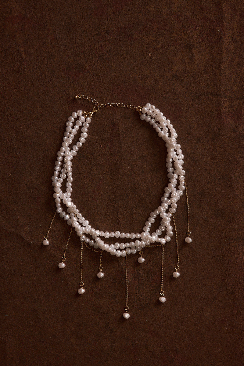 Back view of the pearl piece showing the silhouette and fit.