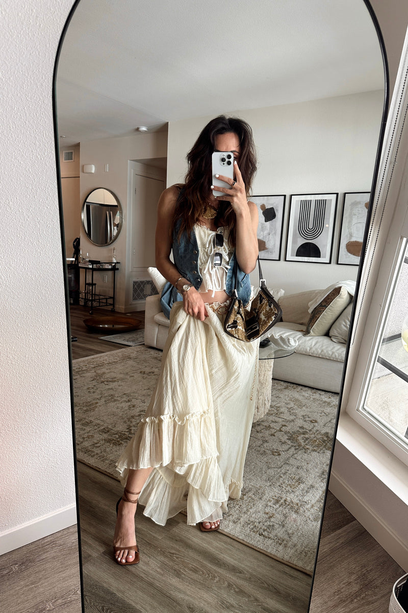 Full-length view of the yellow maxi skirt showing the drape and movement.