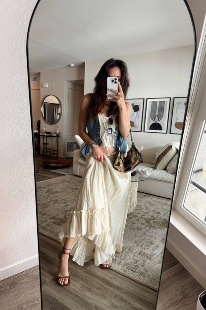 Full-length view of the yellow maxi skirt showing the drape and movement.