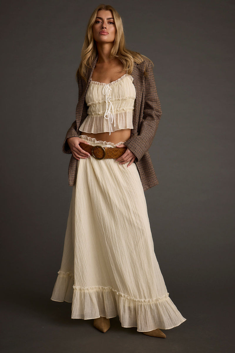 Full-length view of the yellow piece showing the drape and movement.
