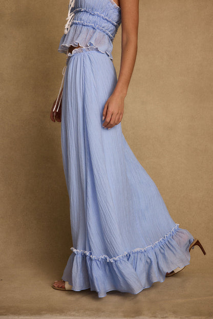 Full-length view of the blue maxi skirt showing the drape and movement.