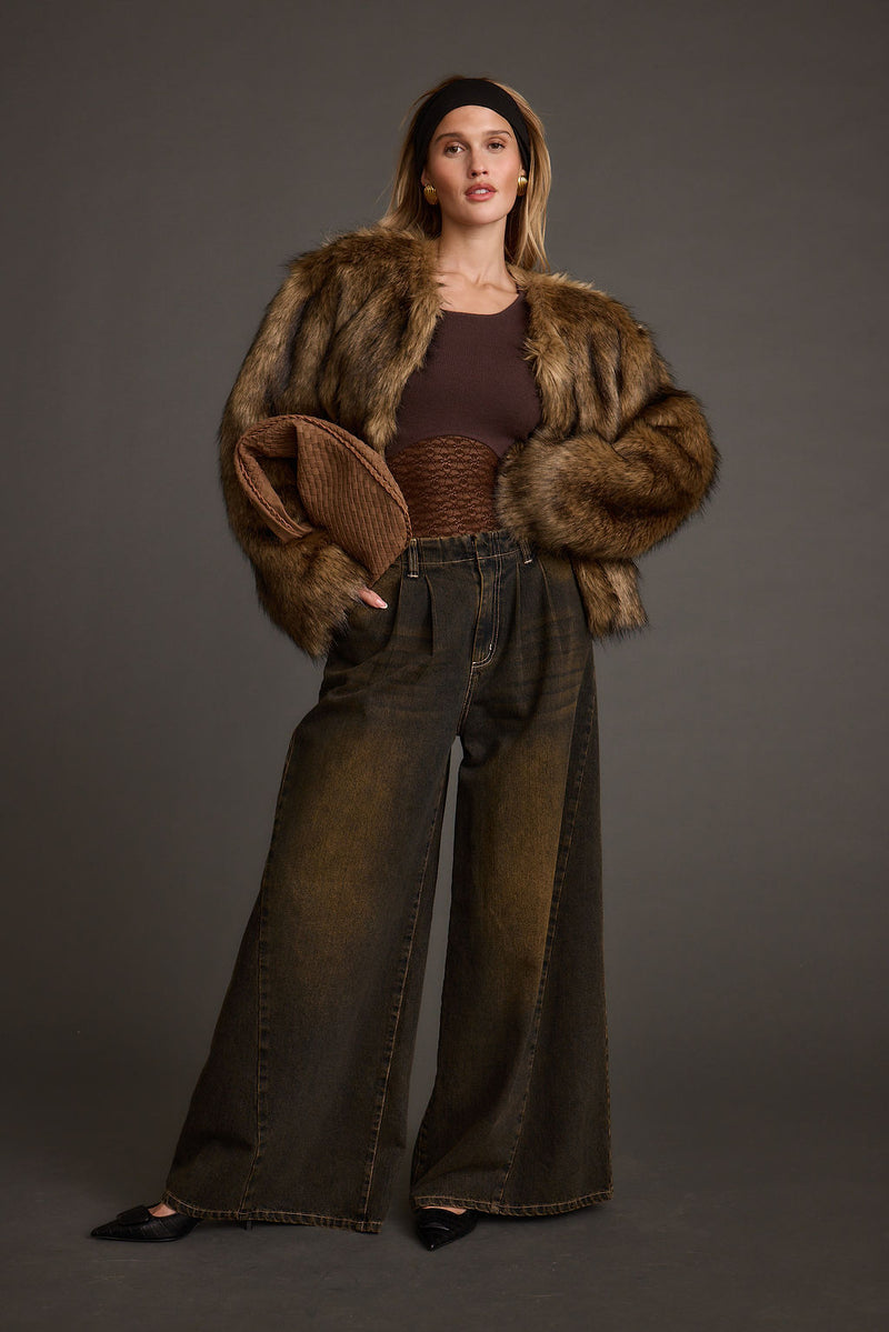 Black wide-leg jeans with elegant accents, a one leg jeans standout.
