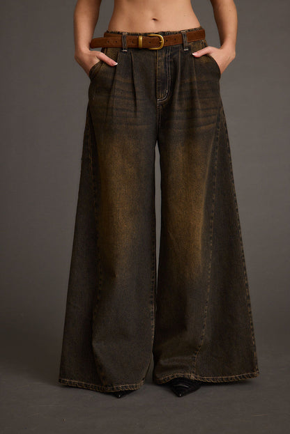 Full-length view of the black jeans showing the drape and movement.