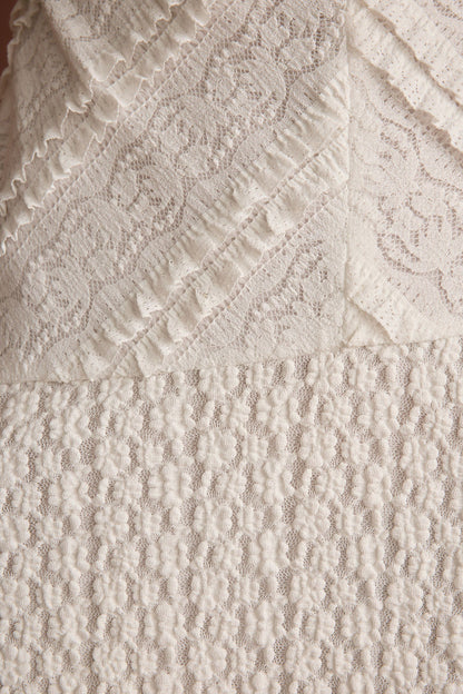 Lifestyle shot of the white mini dress styled for day-to-night versatility.