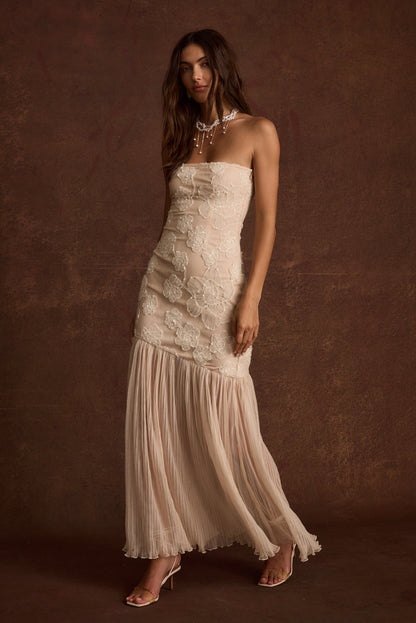 Full-length view of the blush maxi dress showing the drape and movement.