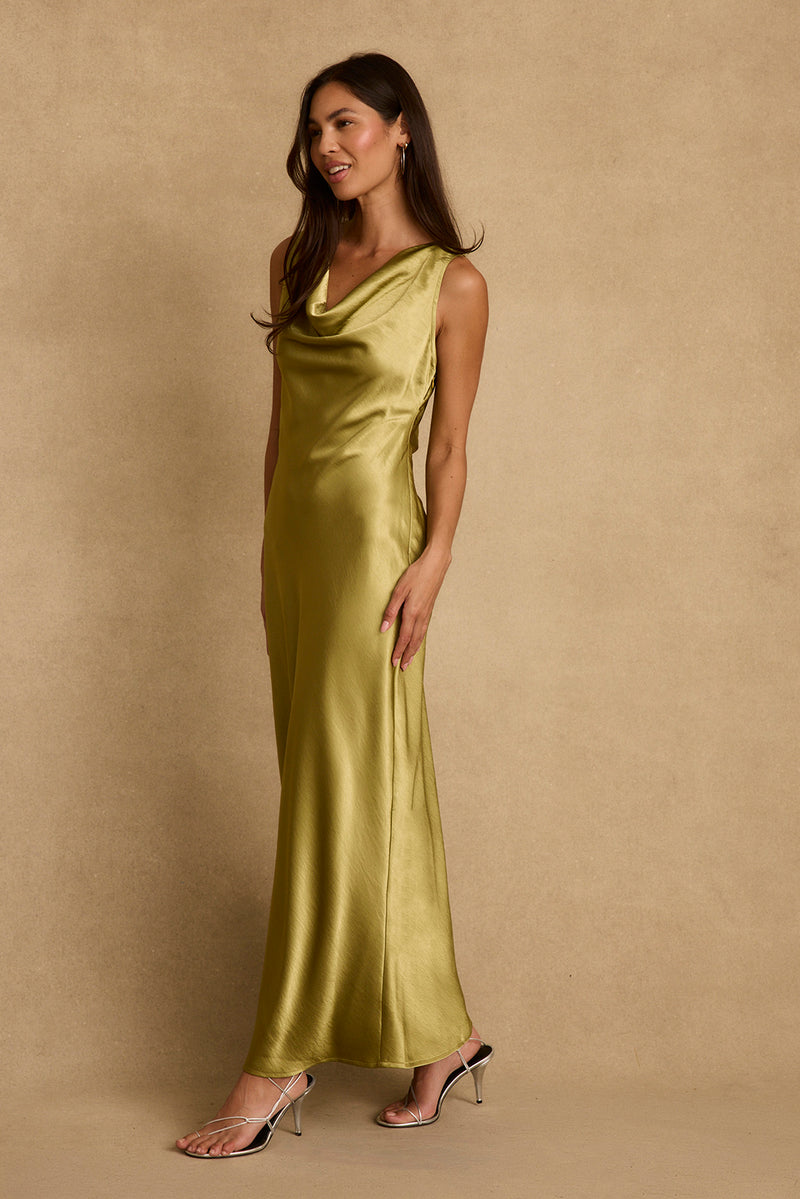 Side view of chartreuse satin maxi dress with cowl neckline, styled with silver heels.