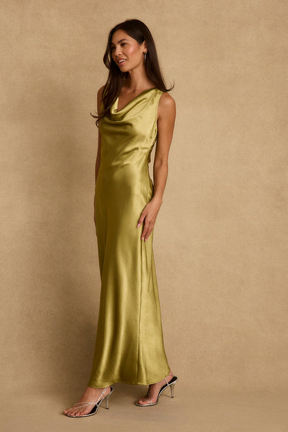 Side view of chartreuse satin maxi dress with cowl neckline, styled with silver heels.