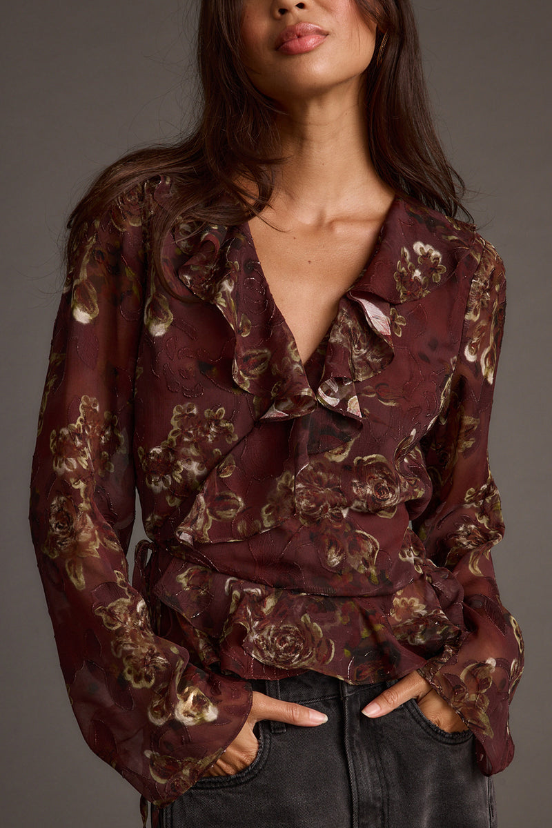 Plum blouse with refined detailing and a flattering silhouette.