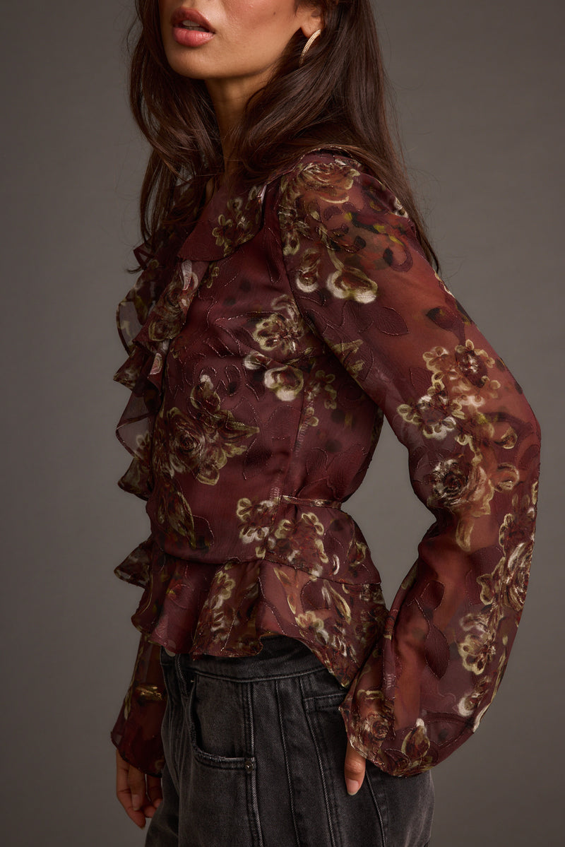 Back view of the plum blouse showing the silhouette and fit.