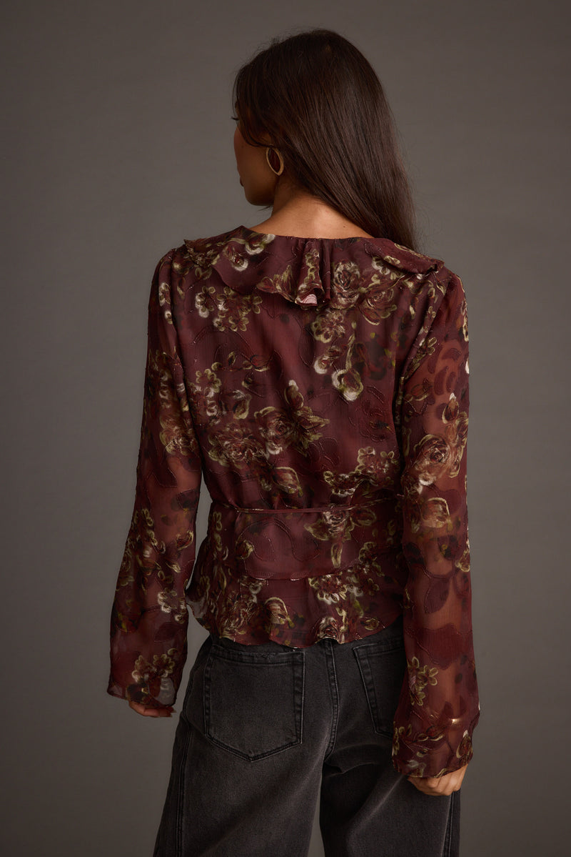 Close-up of the Dominique Plum Floral Blouse showcasing the fabric texture and design details.