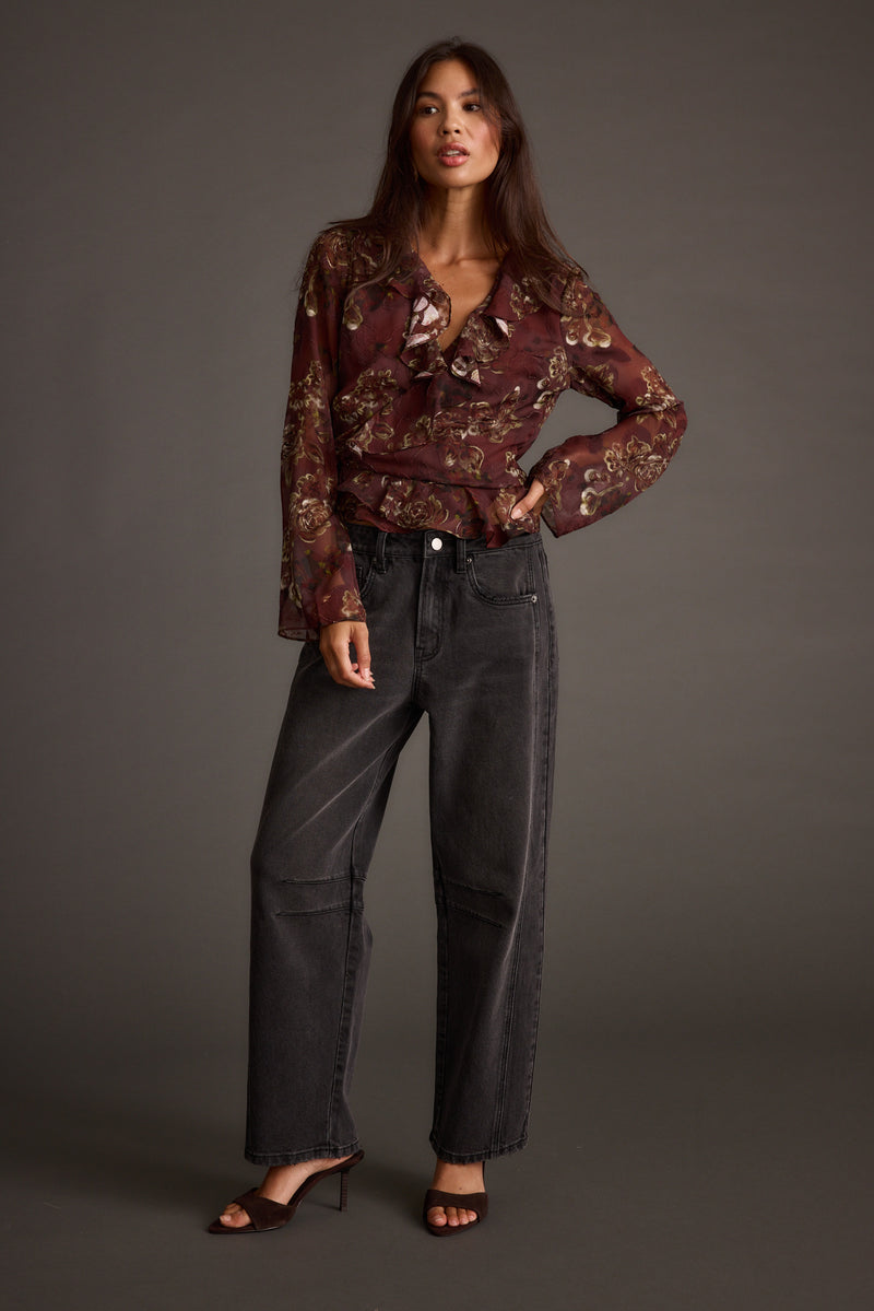 Full-length view of the plum blouse showing the drape and movement.