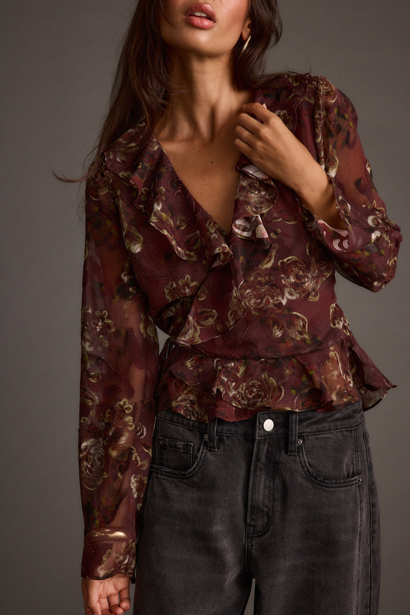 Detail shot of the Dominique Plum Floral Blouse highlighting the design elements.