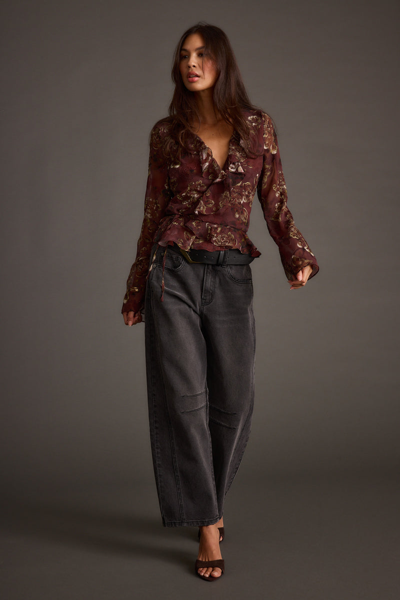 Lifestyle shot of the plum blouse styled for day-to-night versatility.