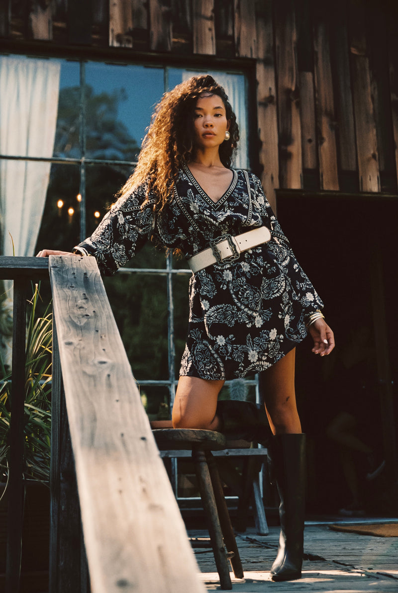 Black mini dress with elegant accents, a white sequin dress essential.