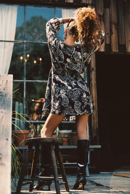 Close-up of the Donna Black And White Floral Mini Dress showcasing the fabric texture and design details.