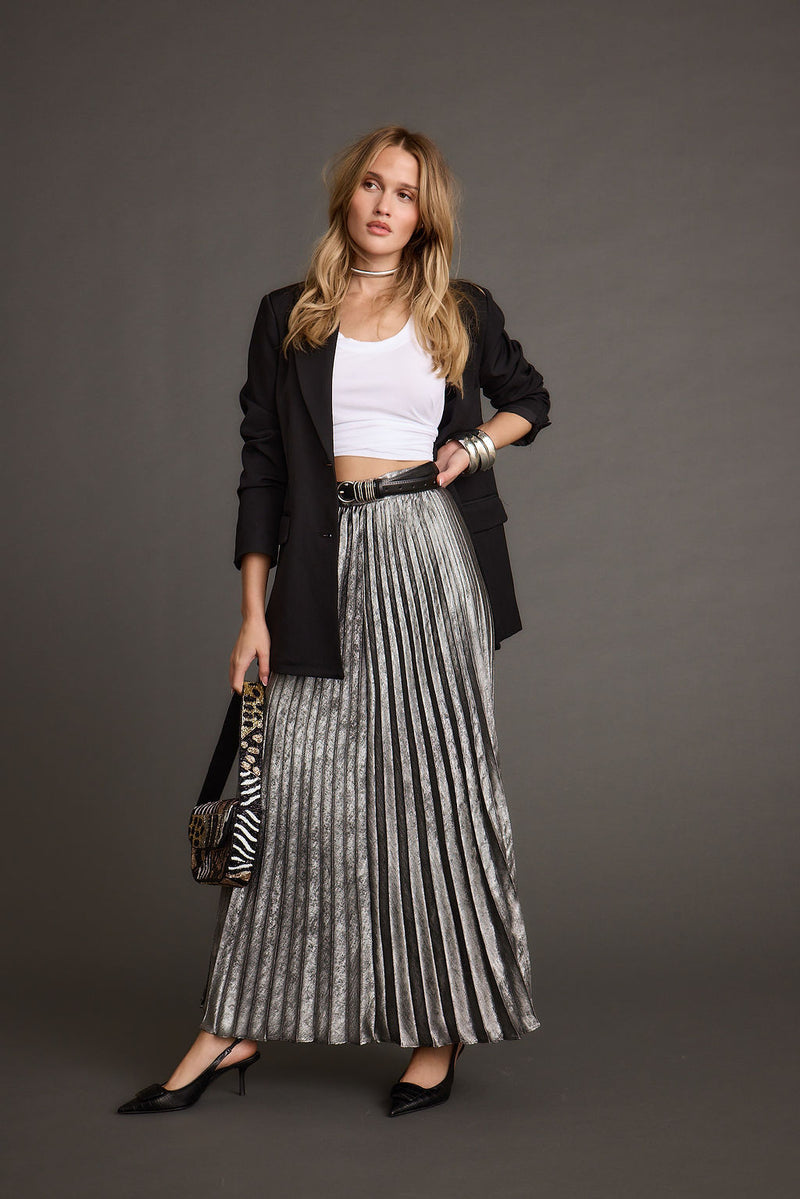 Full-length view of the metallic maxi skirt showing the drape and movement.