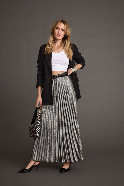 Full-length view of the metallic maxi skirt showing the drape and movement.