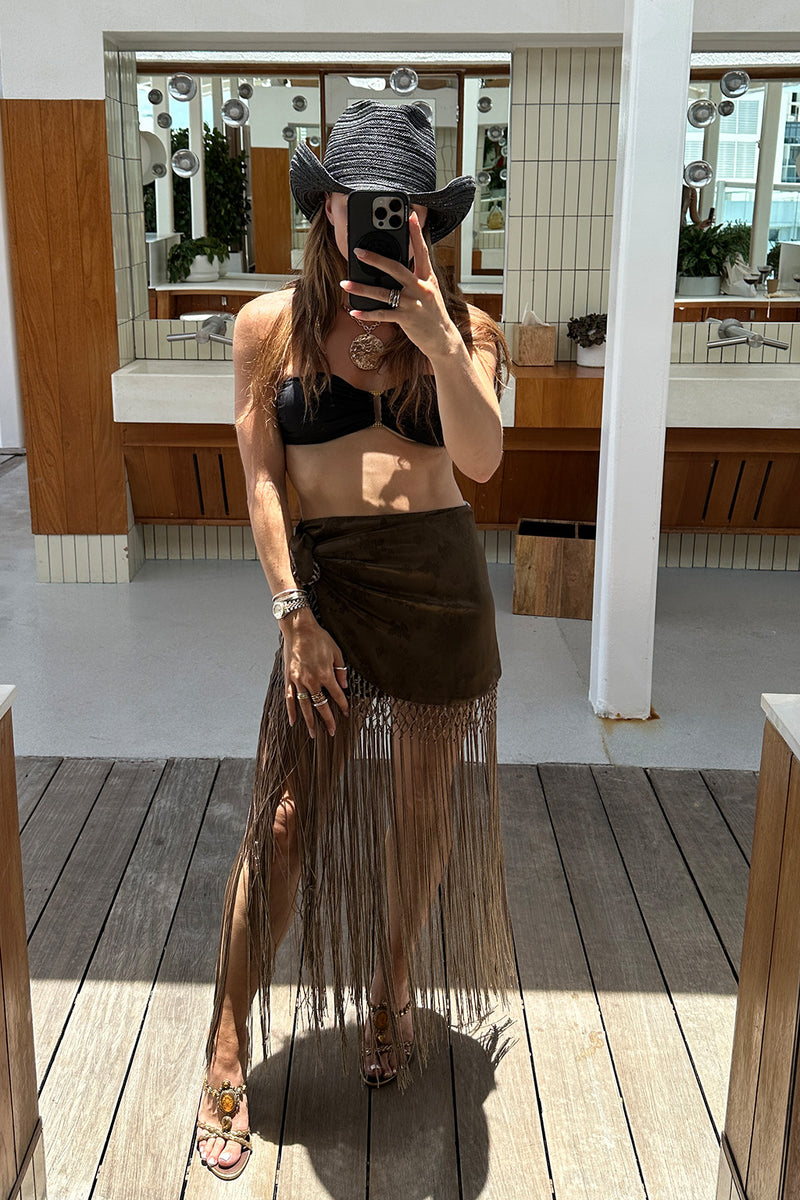 Back view of the olive fringe skirt showing the silhouette and fit.