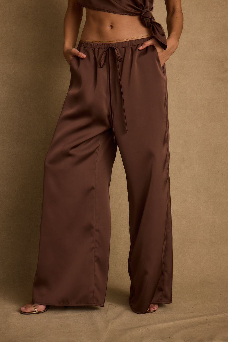 Full-length view of the espresso pants showing the drape and movement.