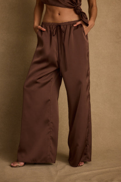 Full-length view of the espresso pants showing the drape and movement.