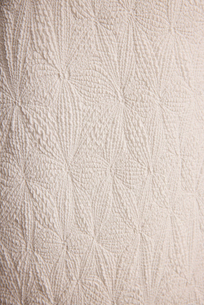 Lifestyle shot of the ivory piece styled for day-to-night versatility.