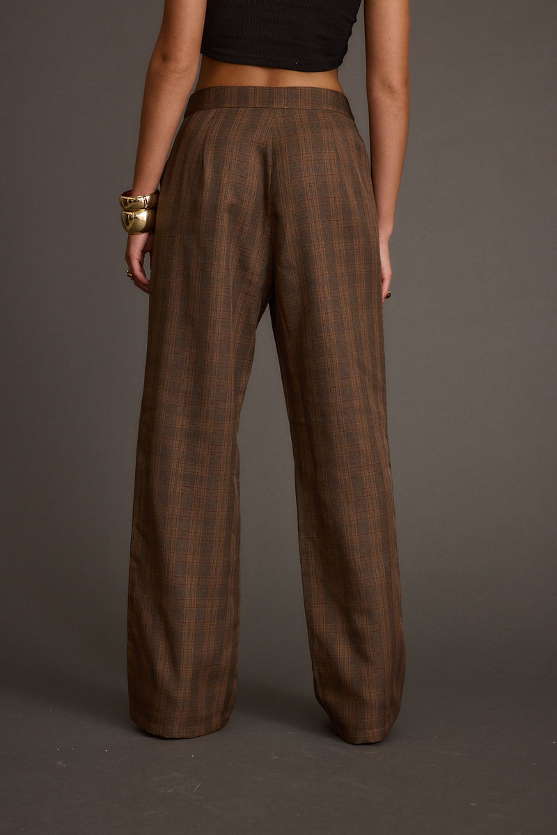 Back view of the tan pants showing the silhouette and fit.
