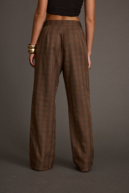 Back view of the tan pants showing the silhouette and fit.