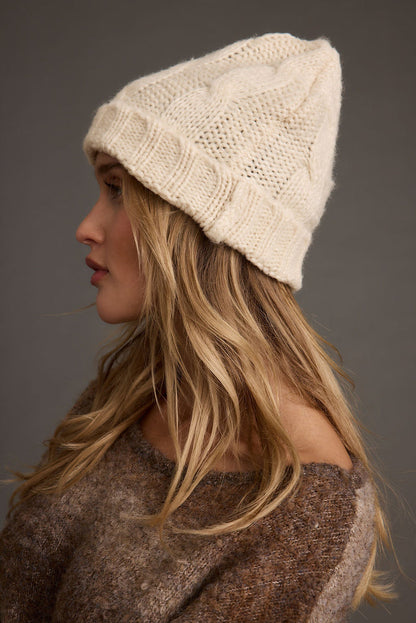 Alternate view of the cream hat showing the design and craftsmanship.