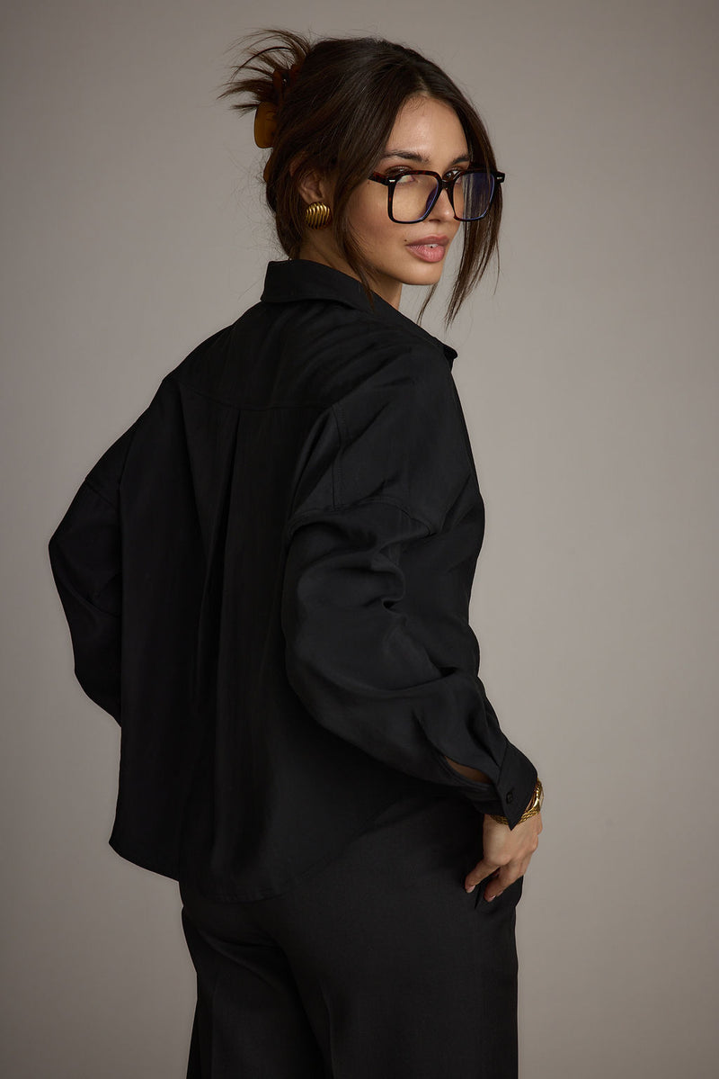 Close-up of the Gisele Black Poplin Button Down showcasing the fabric texture and design details.