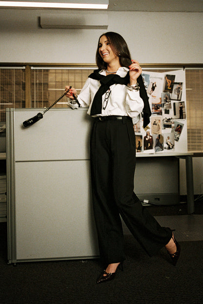 Black wide-leg trousers with refined detailing and a flattering silhouette.