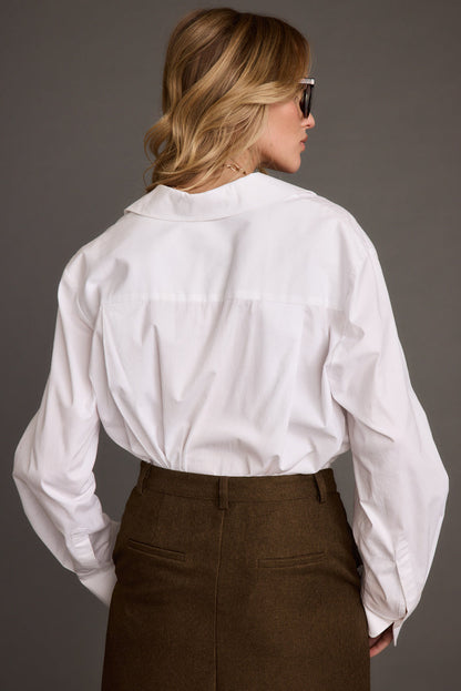 Close-up of the Gisele White Poplin Button Down showcasing the fabric texture and design details.