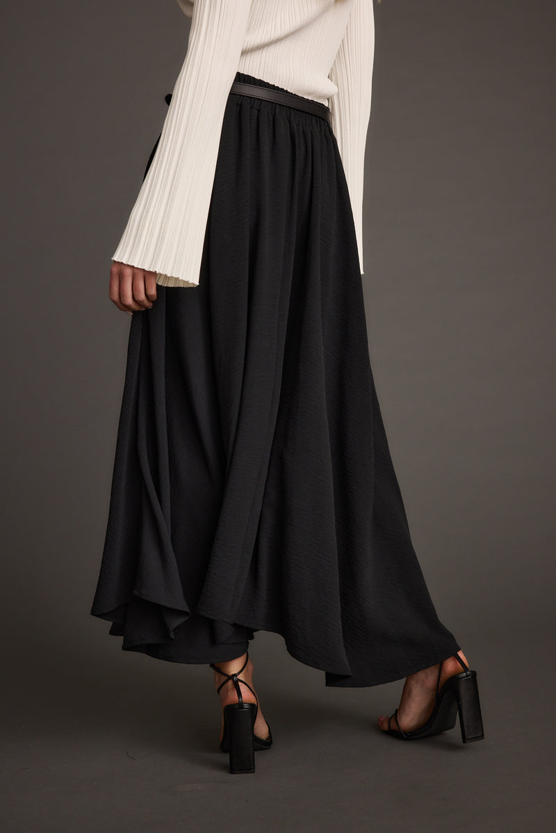 Back view of the black midi skirt showing the silhouette and fit.