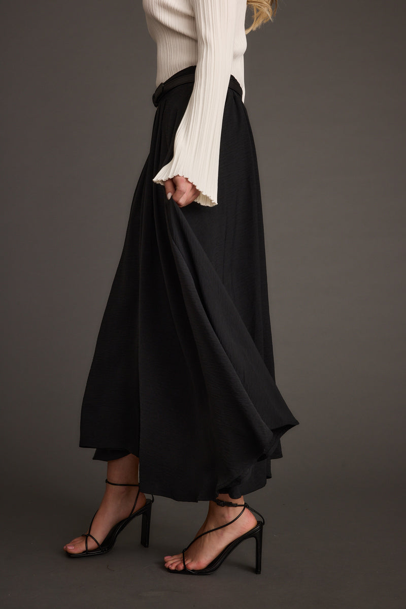 Close-up of the Gloria Black Midi Skirt showcasing the fabric texture and design details.