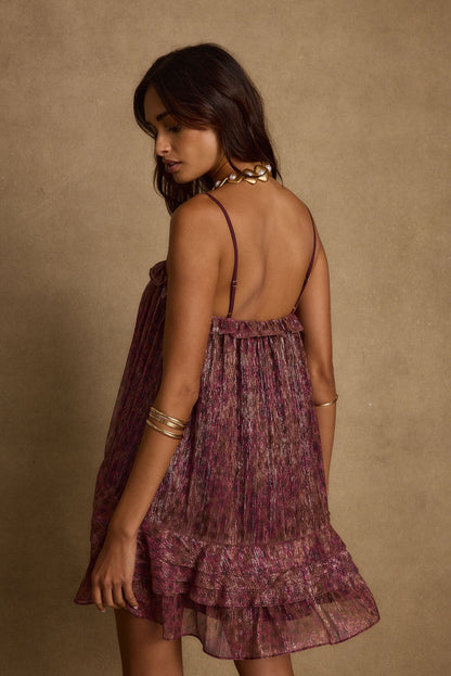 Lifestyle shot of the mini dress styled for day-to-night versatility.