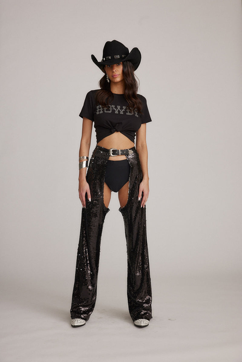 Full-length view of the black pants showing the drape and movement.