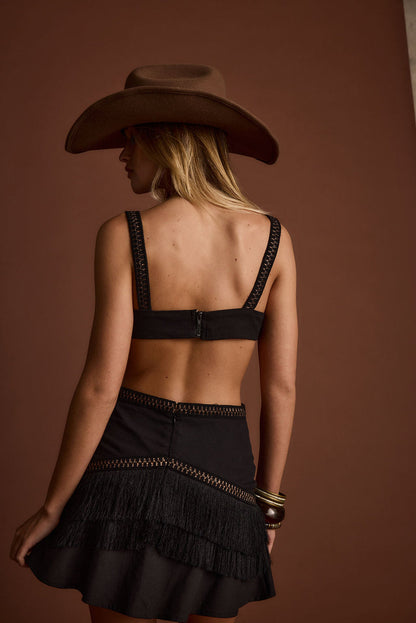 Close-up of the Haven Black Fringe Cutout Mini Dress showcasing the fringe texture and craftsmanship.