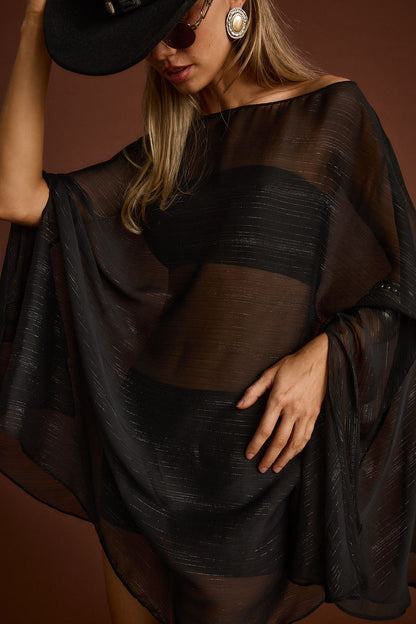 Back view of the black dress showing the silhouette and fit.