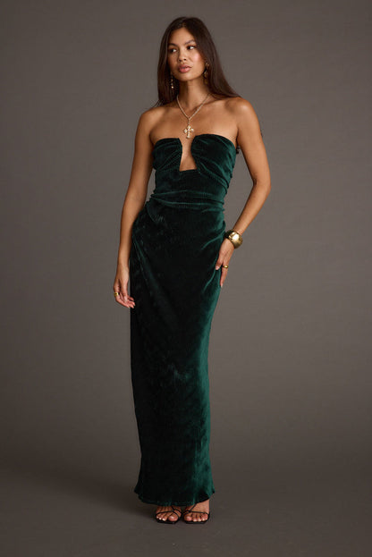 Emerald velvet maxi dress with refined accents, a vacation maxi dress essential.
