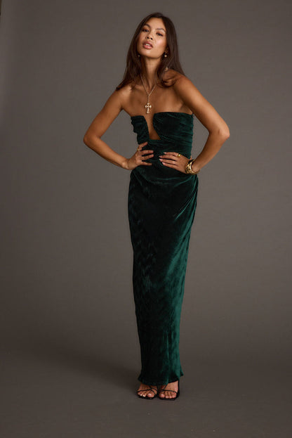 Full-length view of the emerald maxi dress showing the drape and movement.