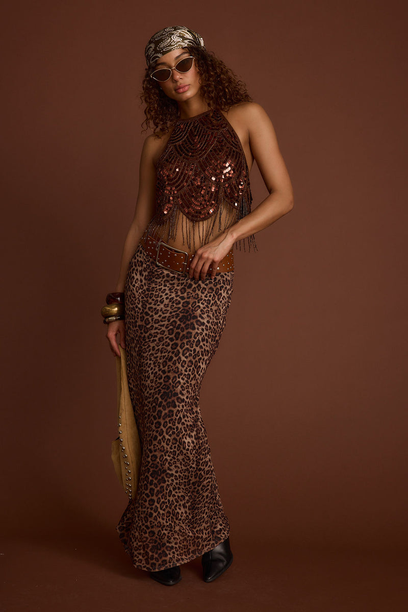 Full-length view of the leopard print maxi skirt showing the drape and movement.