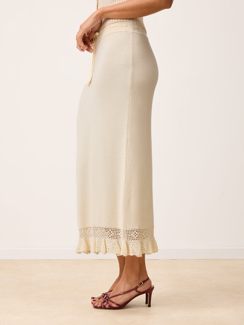 Side view of Lester ecru maxi knit and crochet skirt worn by a mode