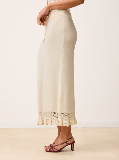 Side view of Lester ecru maxi knit and crochet skirt worn by a mode