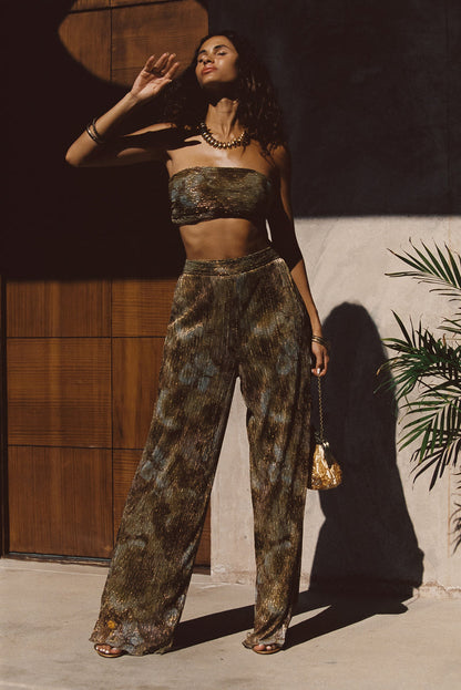 Lifestyle shot of the metallic top styled for day-to-night versatility.