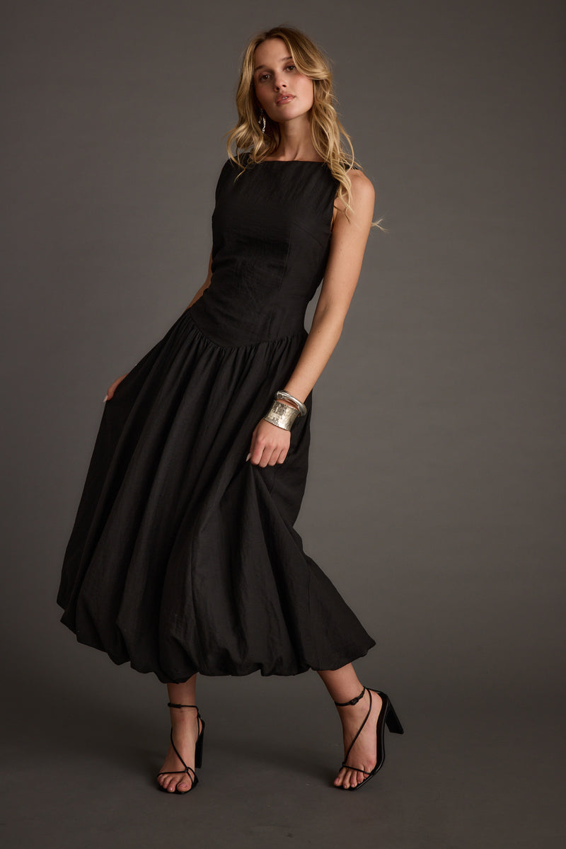Back view of the black midi dress showing the silhouette and fit.