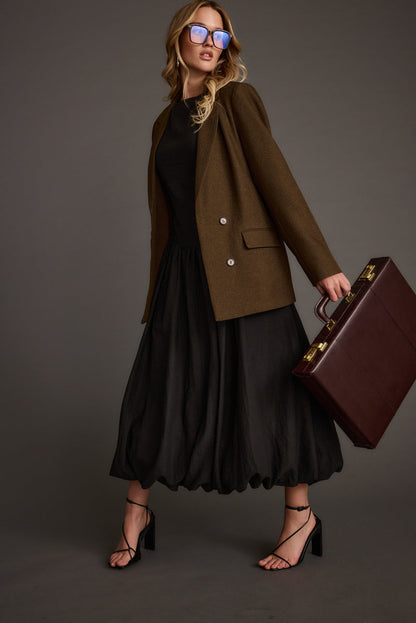 Lifestyle shot of the black midi dress styled for day-to-night versatility.