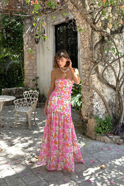 Pink strapless, drop-waist maxi dress with elegant accents, a pink strapless maxi dress essential.