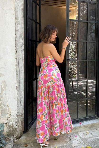 Back view of the pink maxi dress showing the silhouette and fit.