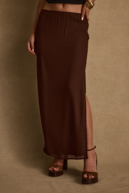 Full-length view of the mocha maxi skirt showing the drape and movement.