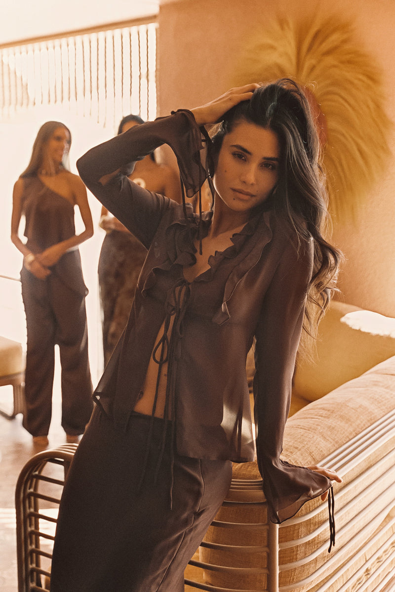 Lifestyle shot of the mocha maxi skirt styled for day-to-night versatility.