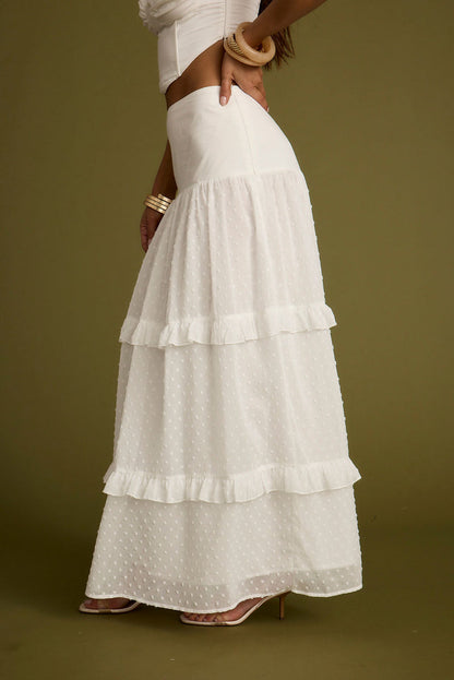 Lifestyle shot of the white maxi skirt styled for day-to-night versatility.